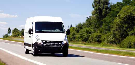 white van travelling on the road